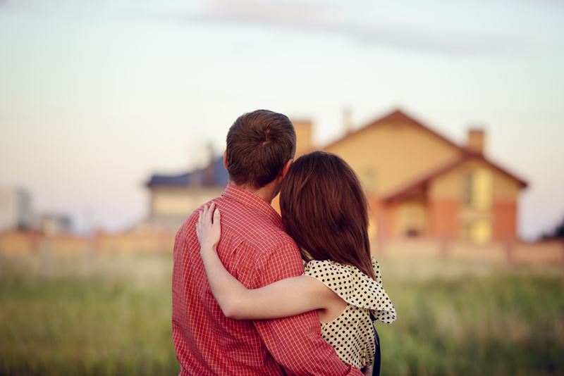 Couple in front of house